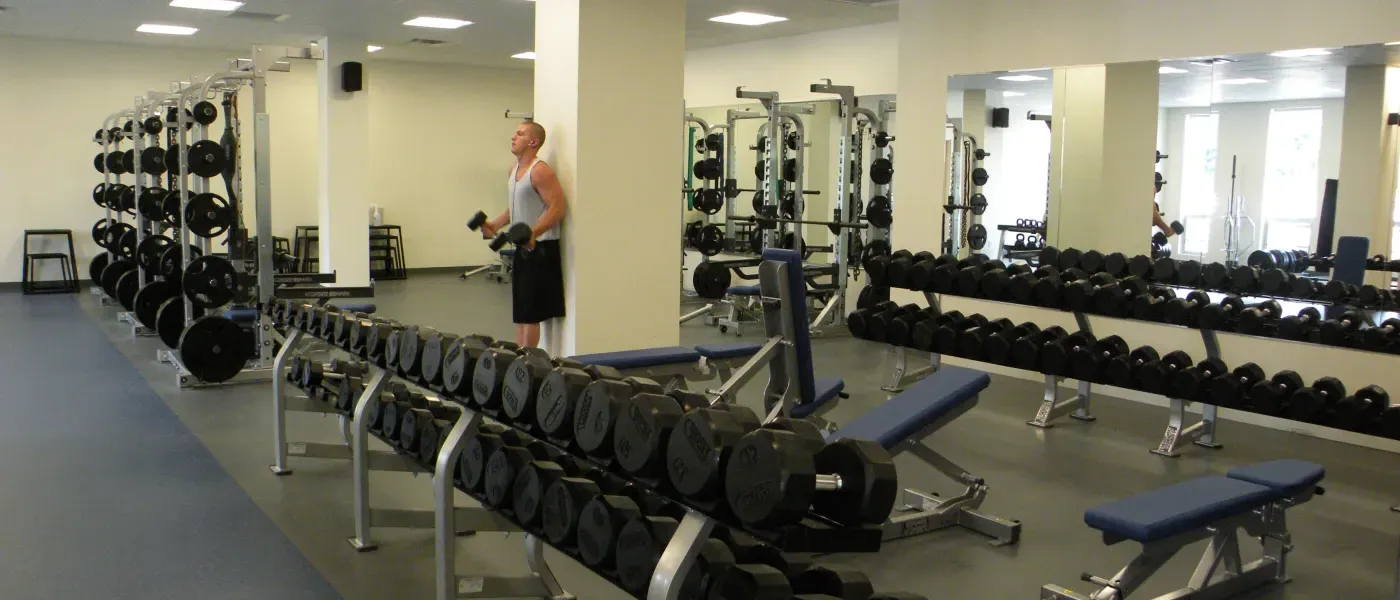 A student uses the weight room on the U N E campus